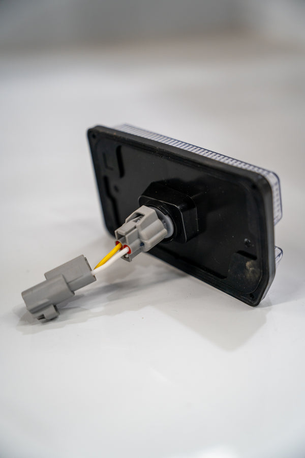 Rear view of clear indicator with wiring harness. Plug and Play for LandCruiser 70 series