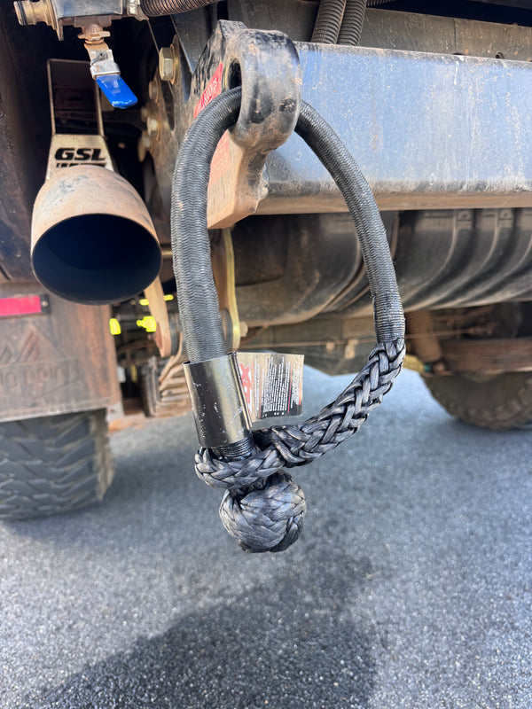 Saber offroad recovery shackle attached to tow bar on muddy landcruiser ready for use 