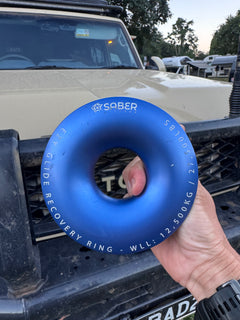 hand holding Saber Ezi glide recovery ring In front of Toyota landcruiser 70 series 