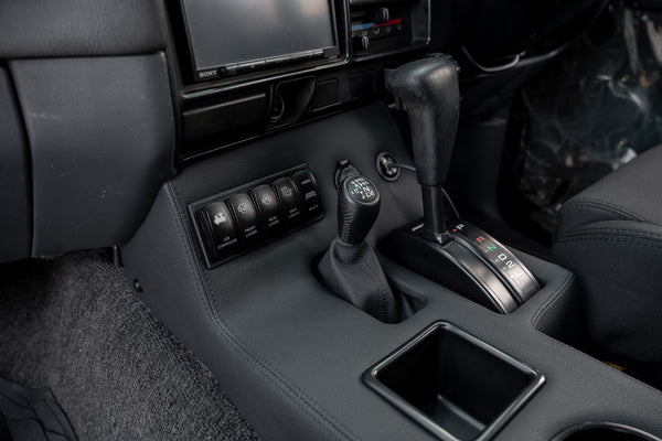 close up view of custom centre console inside Toyota LandCruiser 80 series with custom switches and uhf