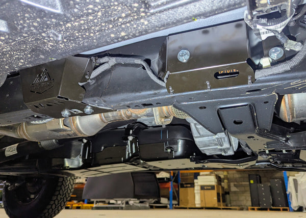Undercarriage view of a ford super duty showing black metal underbody protection, wiring guards installed on car.