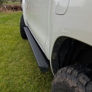 trig point branded side rails rear view on grass installed on Toyota HiLux n80